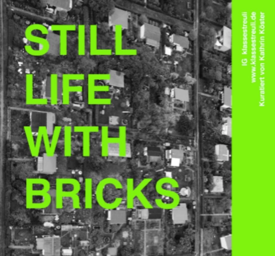 Image: A black and white bird's eye view of an allottment settlement that is slightly tilted to the side. The image is overlaid with bright green writing saying "Still life from bricks".